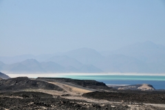 Lake Assal is a crater lake in the Danakil Desert in central Djibouti. Dormant volcanoes and black lava fields back its emerald water. More than 150m below sea level, it’s the lowest point in Africa. The wet section of the lake is a body of extremely salty water fed by hot springs. The dry section features a white salt bed from which lake water evaporated over the years. Salt is extracted in slabs