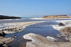 It is located at the western end of Gulf of Tadjoura in the Tadjoura Region, touching Dikhil Region, at the top of the Great Rift Valley, some 120 km (75 mi) west of Djibouti city. Lake Assal is a saline lake which lies 155 m (509 ft) below sea level in the Afar Triangle, making it the lowest point on land in Africa and the third-lowest point on Earth after the Sea of Galilee and the Dead Sea