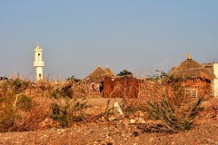 Mosque in the background with next to nothing living conditions in the foreground. What a contrast.