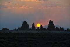 The sun balancing and leaning on the Chimneys.