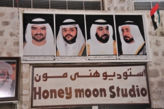 This photo over the door of a photographer's studio says it all. What happened to the Brides photo? Only the men?