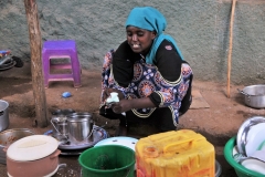 Young girl hard at work in the market. She is literally cooking in front of us and selling her food to go.