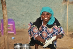 Young girl hard at work cleaning up here recent cooking.