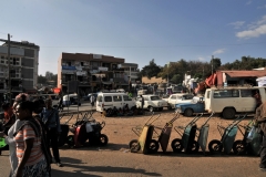 I call this wheelbarrow square. Notice the people sitting in the shade of a van in the background due to the heat of the day. It is just outside of the Buda Gate.