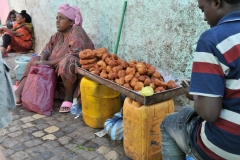 Counting his money. Looks like it was good day at the market.