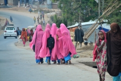 Young girls walking home from school in their pink uniforms.. hijibs.