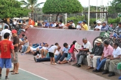 Local crowds of men watching a form of volley ball played