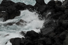 Churning sea against the black lava rocks along the coast