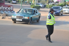 A traffic police woman directing the congested traffic and doing a good job too.