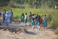 Children walking to school as adults are walking to work.