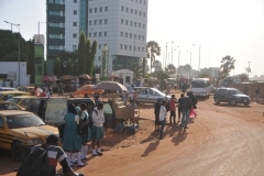 Here we are about to enter a round about of unpaved road, in the city, with kids going to school, animals along side the highway, traffic going in all directions.