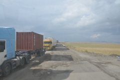 Russian trucks lined up leaving Georgia entering Armenia.