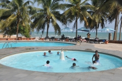 Young children playing in the kids pool.  I have an idea that none of the kids in this pool knew how to swim. thus they were in the smaller pool in the foreground.