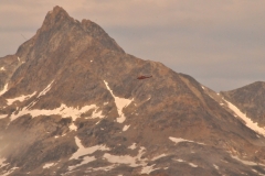 Helicopter arriving into Tasiilaq air space preparing for a landing from Kulusuk.