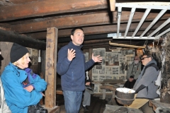 A day earlier while walking around you saw a photo of the front of the Turf House built under ground.  This is the inside of the old Turf House . A guide, from the museum,  is telling us about life in Greenland hundreds of years ago.