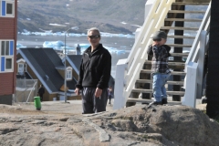 Looks like Grandpa looking out for his grandson. The sun is so bright even the little ones wear dark glasses for eye protection.