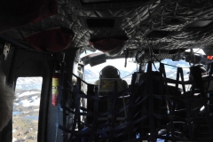Looking through the front and side windows of the helicopter  through the cockpit ahead.