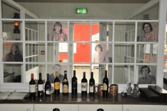 Interesting room divider with the faces of locals from the past cut into glass.