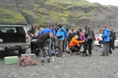 A group of Icelandic students getting ready to hike up onto the glacier.  See the pile of crampons behind the truck.