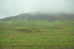 Mist clouds shroud the countryside in green and white colors.