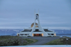 Almost 1 a.m. in the morning, surrounded in evening light from the sun that does not set this time of year. The entrance, of the church, lies between two sweeping arms leading up to the bell tower. The style is modernistic, in common with many Icelandic churches; its appearance incongruous against the surrounding landscape. The church is also used as a concert venue. A spectacular sight against the night time sky.