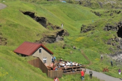 You can see the trail with people  coming in from the distance passing by the restaurant.  Also at the top of the photo is a glimpse of the house with the blue roof.