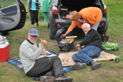A foursome out for the day with a picnic near the river. Looks like they have everything needed for a fun afternoon.
