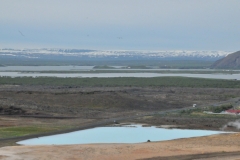 Mývatn is a shallow lake situated in an area of active volcanism in the north of Iceland, not far from Krafla volcano. It has a high amount of biological activity. The lake and the surrounding wetlands provides a habitat for a number of waterbirds, especially ducks. The lake was created by a large basaltic lava eruption 2300 years ago, and the surrounding landscape is dominated by volcanic land forms, including lava pillars and rootless vents. The effluent river Laxá is known for its rich fishing for brown trout and Atlantic salmon.