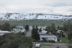 Our hotel Icelandair Akureyri Hotel in the center of the photo with snow in the mountains behind the city not far away.