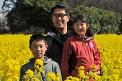 Friends Kazuo Yamaguchi with his son Ray and daughter Sarah in Hamarikyu Gardens surrounded with wild mustard. The park is a haven of peace in the middle of Tokyo.