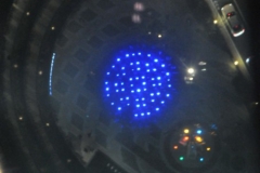 Looking straight down through the glass sky walk bridge to the bottom of the lighting of Tokyo Skywalk