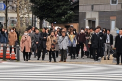 Crowds waiting to cross the street to go to the market