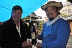 Councilman Kern presenting a bottle of Beach House wine, from Oceanside, to Yamadason for his hospitality to all of us.