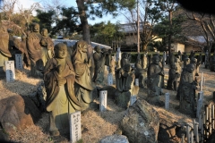 View from the street of the statues with the sun setting on them.