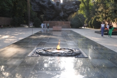 Across the street from the museum is the Almaty's Panfiloov Park is named for the Panfilov division, a group of World War II heroes who gave their lives in the defense of Moscow. Inside the park, there’s a memorial to fallen Soviet soldiers that’s based on that famous  story of heroic sacrifice.  At one end of a long black plinth is an eternal flame dedicated to fallen soldiers of the Russian Civil War and World War II. At the other end is a black stone memorial, with the stoic faces of soldiers from all 15 Soviet Republics. Emerging at the front of the statue is a single soldier with arms spread up and out as if in flight, one hand wielding a fist full of grenades.