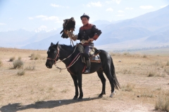 After driving for hours leaving Bishkek, across the vast landscape of Kyrgyzstan, our bus turned down an off the way highway and then onto a dirt road. At the end of this road was one of the travel adventures of a life time. The sight of a Golden Eagle being held by the Kyrgyz Nomad Eagle Hunter who trains  their deadly predators in the this fast open area and mountains.  A window into the past and a demonstration, of natures raw power. I felt at that instant I had hit the jackpot of a life time to see this magnificent animal in the wild. I was over whelmed with emotion. I thought I would have to travel to Mongolia to experience this.