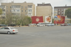Driving through a local town we see the remnant signs from the old Soviet Union on the side of the building.