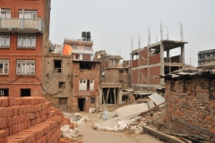 Look straight ahead at the building with the white doors and the blocks stacked partially below where a window will go one day.
