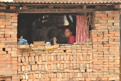 A woman is already working again with her sewing machine. Life is returning little by little