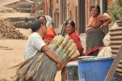 A vendor selling brooms in the neighborhood