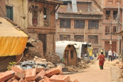 Survivors from the earthquake make quansat huts to live in until they can rebuild.