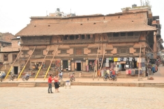 Life in Kathmandu's Durbar Square. Ancient courtyards, Buildings being helped with steel poles and beams for support. People are working in these leaning and crumbling buildings today. Old temples and twisting streets where artisans will practice age old traditions. It was Kathmandu's Old City.