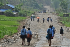 They are so glad to be able to go to school. In this case when we located the school it had been damaged by the earthquake and they were outside learning.