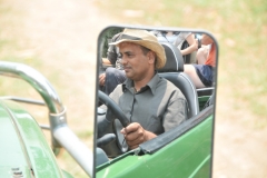 I took this photo of our guide driving, looking into the side mirror, from a rear seat.