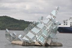 Looking out from the lobby area at a glass art work in the harbor