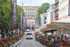 Lots of people out walking in the warm summer afternoon in the city.