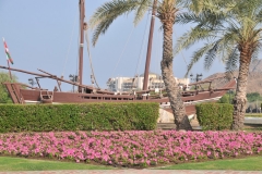 Traffic with a Dohw in the forground and the Al Bustan Palace Hotel in backdrop
