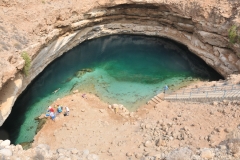 Brimmah Sinkhole or Hiwiyat Najim, Dabad Sinkhole. A giant depression where sea water has merged with fresh water. Two flights of steps take you down to a dazzling pool of blue and green water.