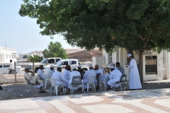 Men getting together to socialize in the shade of the morning sun