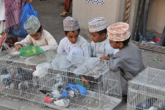 Young boys selling birds